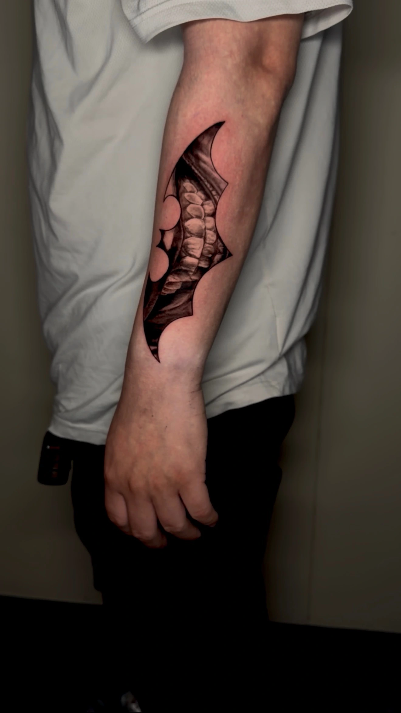 Batman baterang with joker laugh tattoo